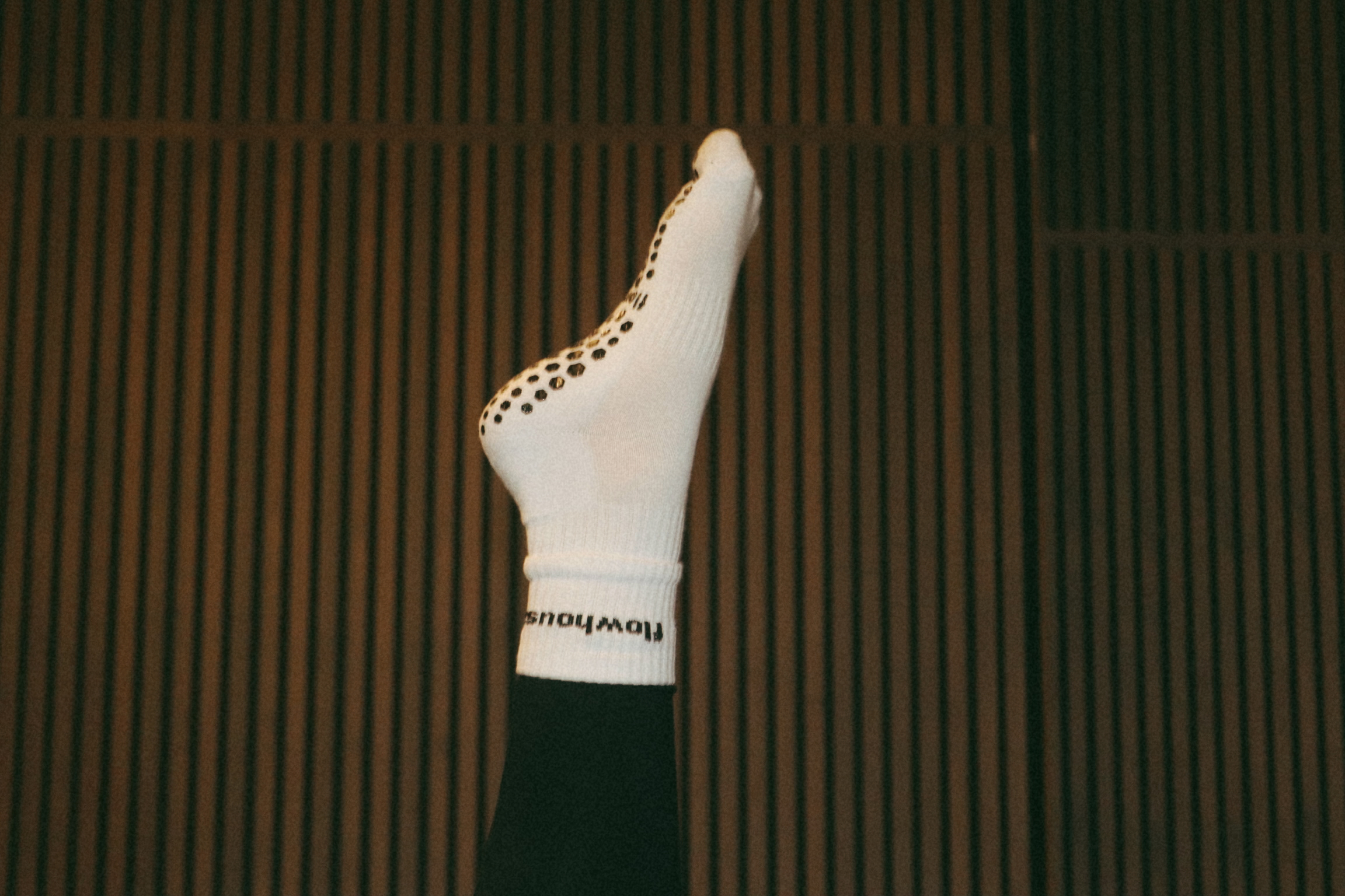 Detail of a hand resting on the brass barre