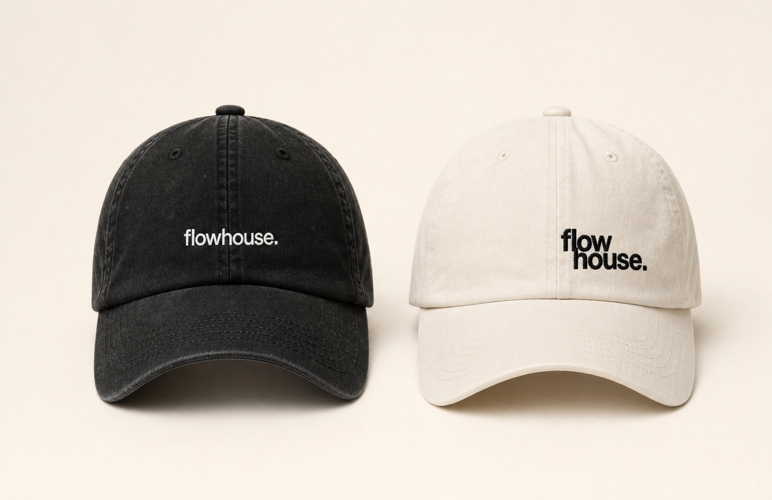Two washed dad caps in black and cream — flat lay.